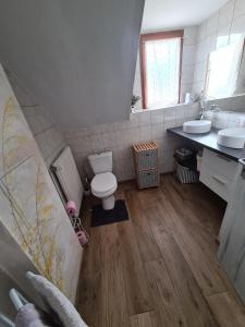 uma casa de banho com WC e 2 lavatórios em La Brise em Saint-Maurice