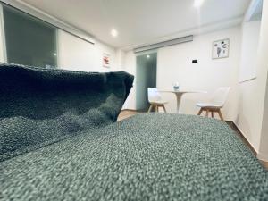 a bedroom with a bed and a table and chairs at B&B Civico 35 in Chieti