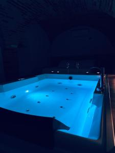 a hot tub in a dark room with blue lighting at B&B Civico 35 in Chieti