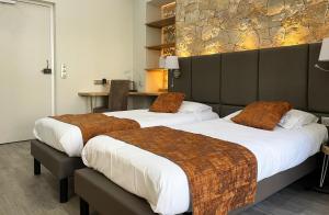 dwa łóżka w pokoju hotelowym z dwoma łóżkami w obiekcie Hotel Busby w Nicei