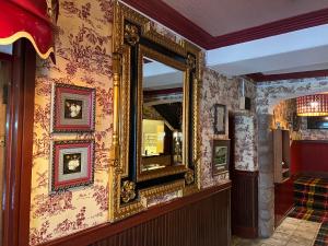 a mirror on a wall in a room at Strathpeffer Hotel in Strathpeffer