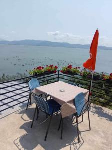 a table and chairs with a view of the water at Apartmant Lidija in Nov Dojran