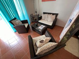 a living room with chairs and a couch and a table at Charming 1-Bed Studio in Simpson Bay - Beacon Hill in Simpson Bay