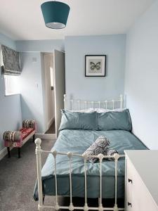 a bedroom with a bed with a green comforter at Ground floor flat in Keynsham