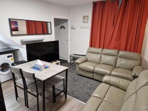 a living room with a couch and a table at Chester Le Street's Emerald 3 Bed House in Chester-le-Street