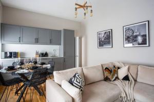 a living room with a couch and a table at Eden Apartment - Islington - 2 bed with terrace in London