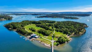 an island in a body of water with a house at Apartment in Sandvika Bærum - Great view and Attractive in Østre Jong