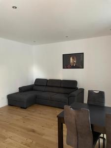 a living room with a couch and a table at AEGIDA BEACHFRONT apartment in Koper