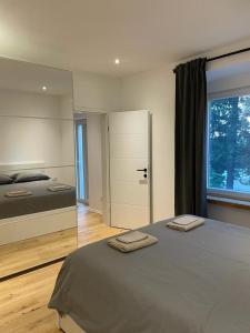 a bedroom with a bed with two towels on it at AEGIDA BEACHFRONT apartment in Koper