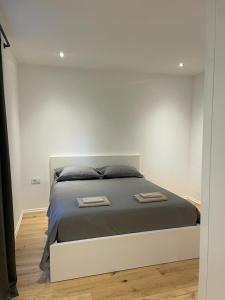 AEGIDA BEACHFRONT apartment في كوبر: غرفة نوم عليها سرير وفوط