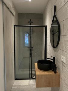 a bathroom with a shower with a black sink at AEGIDA BEACHFRONT apartment in Koper +6 photos