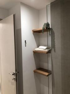 a bathroom with a shower and a shelf with towels at Anastasia Suite/byArtistUnknown in Vari