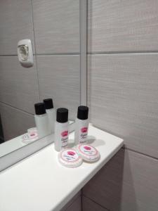 a bathroom counter with three bottles of cosmetics on it at Orhidea House in Ohrid +102 photos