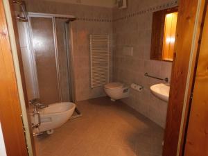 a bathroom with a toilet and a sink at Ski Residence in San Martino di Castrozza