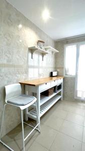 a kitchen with a desk and a chair in a room at Los Naranjos close to Puerto Banus in Marbella
