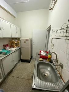 a kitchen with a sink and a refrigerator at Apartment first floor for rent near commercial market satellite town Rawalpindi in Rawalpindi