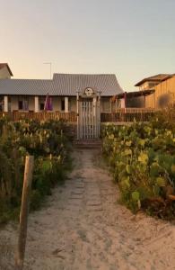 a house with a gate in a field of cabbages at Casa do Point in Saquarema