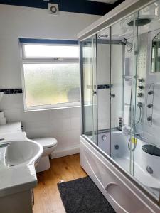 a bathroom with a shower and a toilet and a sink at MM Short Stays in Birmingham