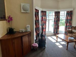 a living room with a couch and a table at Strathpeffer Hotel in Strathpeffer