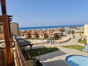 a view from the balcony of a building with a pool at كورونادو in Zāwiyat ‘Abd al Mun‘im