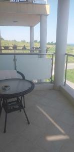 a patio with a table and a chair on a balcony at Апартамент Лана in Byala