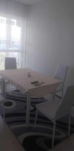 a table and chairs in a room with a table and chairs at Апартамент Лана in Byala