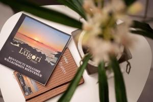 a book sitting on top of a table with a flower at Casa Lugori in Torre Dei Corsari