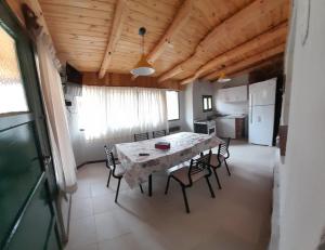 a kitchen and dining room with a table and chairs at CABAÑAS RINCON DEL PLATA in Potrerillos