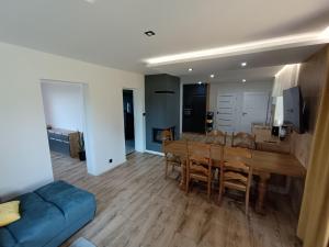 a dining room and living room with a table and a couch at Siedlisko u Agi nad Biebrzą in Grabowo