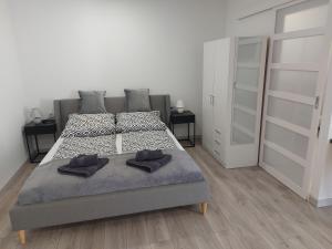 a bedroom with two beds and two walk in closets at Belvárosi apartmanház 2 in Szigetvár