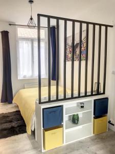 a bedroom with a bed with a black crib at Street Home in Boulogne-sur-Mer