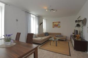 a living room with a couch and a table at Ferienwohnungen Sonneberg in Sonneberg +19 photos
