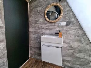 a bathroom with a sink and a mirror at Glamping A frame lake in Barajevo