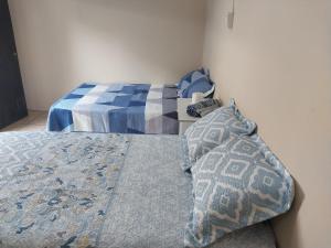 a bedroom with two beds with blue and white at Hostal San José in La Unión