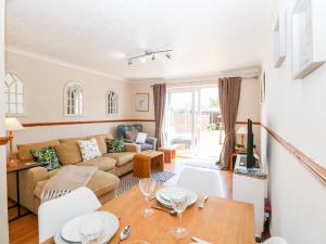 a living room with a couch and a table at Drifters Cove in Great Yarmouth