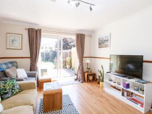 a living room with a couch and a flat screen tv at Drifters Cove in Great Yarmouth