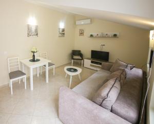 a living room with a couch and a table at Goga Apartment in Kotor