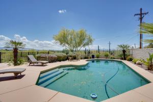 a swimming pool in a yard with a bench next to at Updated Tucson Home with Panoramic Mtn Views and Pool! in Tucson