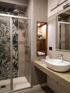 a bathroom with a sink and a shower at Splendid Room Suites in Turin