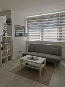 a living room with a couch and a coffee table at Quince in Bor