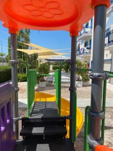 a playground with a slide in a park at Campitur in Campomarino