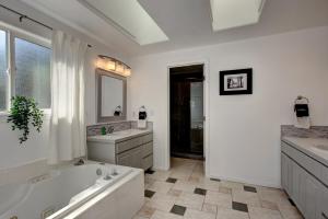 a white bathroom with a tub and a sink and a bath tub at Serenity Gardens near the river walk in Boise +33 photos