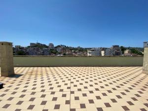 a room with a checkered floor and a city at StartApart City Center in Durrës