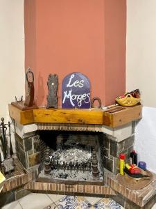 a living room with a brick fireplace with a sign at Escapada rural para descansar - Cicloturismo - Provincia Girona in Osor