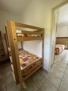 a bedroom with two bunk beds in a room at VVF Château sur la Vienne Lac de Vassivière in Nedde