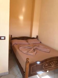 a bed with a bow on it in a room at HOTEL FIRENZE in Tale