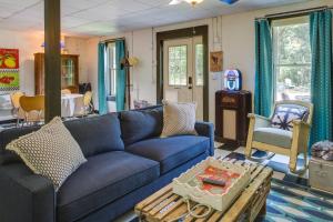 a living room with a blue couch and a table at Killen Vacation Rental Walk to Wilson Lake! in Killen