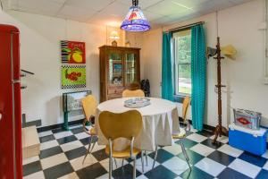 a dining room with a table and chairs on a checkered floor at Killen Vacation Rental Walk to Wilson Lake! in Killen