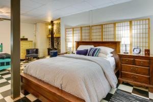 a bedroom with a large bed and a dresser at Killen Vacation Rental Walk to Wilson Lake! in Killen