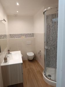 a bathroom with a toilet and a sink and a shower at La casa di Umberto in Piediluco +6 photos